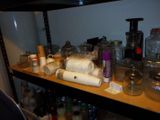 a shelf full of bottles and jars on a shelf