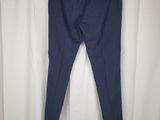 a pair of blue pants hanging on a white curtain