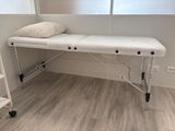 a white table with a pillow on it in a room