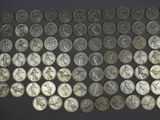 a pile of silver coins sitting on top of a black surface