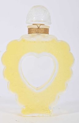a small glass bottle with a heart inside of it