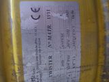 a close up of a yellow barrel with a sticker on it