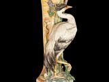 a bird that is sitting on top of a vase