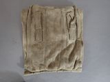 a pair of pants on a table with a pair of scissors