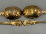 three spoons that are sitting on a table