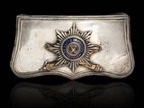 a close up of a belt buckle with a badge on it