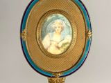 an image of a picture of a woman in a blue dress on a gold stand
