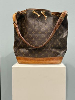a brown and tan purse sitting on top of a white box