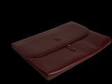 a close up of a brown leather case on a black background