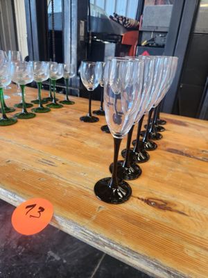 many wine glasses sitting on a table with a price tag