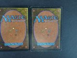 two decks of magic the gathering deck cards on a black surface