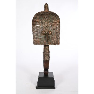 a bronze statue of a man with a large head on a wooden base