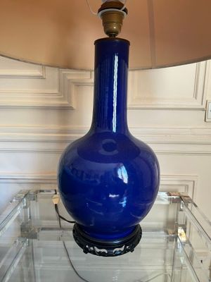 a blue lamp that is sitting on a glass table