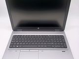 an open laptop computer sitting on top of a white table
