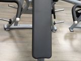 a black and silver bench in a gym with other equipment