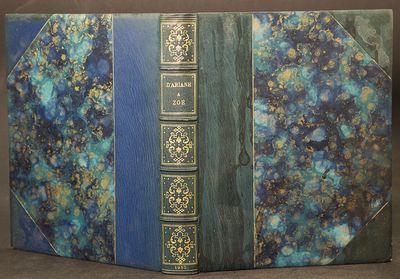 an old book with a blue cover sitting on top of a table
