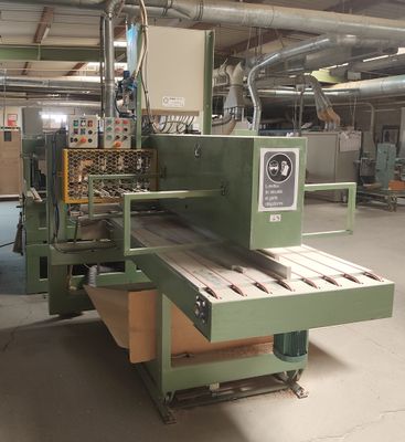 une photo d'une machine en train de scier un morceau de bois