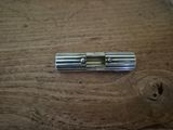 a small metal object on a wooden table