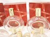 three bottles of perfume sitting on top of a table next to each other