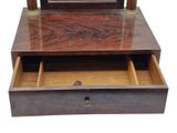 a wooden dresser with a mirror on top of it