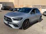 mercedes gla suv in a parking lot with cars parked in the background