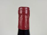 two bottles of wine sitting next to each other on a table