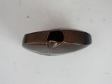 a metal object with a hole in it on a white surface