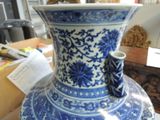 a large blue and white vase sitting on a table