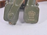two army green military boots that are on a table