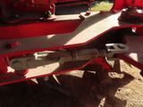 a close up of a red truck with a flat tire