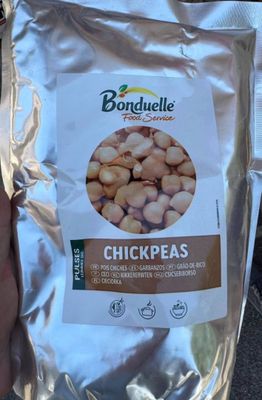 a bag of chickpeas in the hand of a person