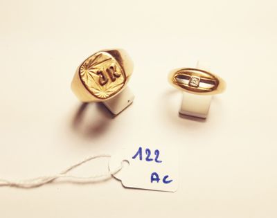 two gold rings and a tag with the word all a c written on them