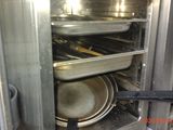 an image of a kitchen with pots and pans in the oven