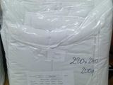two bags of white pillows on a table