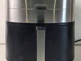 a black and silver air fryer sitting on a counter