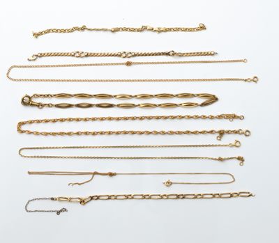 a collection of gold chains and bracelets