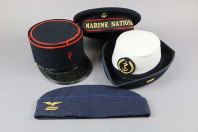 three hats and a hat case sitting on a table