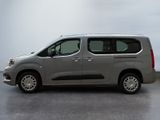 the silver van is parked on the concrete floor in the room