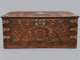 an old wooden box with carvings on the sides
