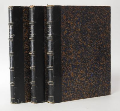 three books are lined up in a row on a white surface