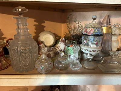 a shelf full of glass vases and other decorative items