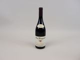 a bottle of wine sitting on top of a white table