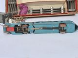 a toy train sitting next to a suitcase on a white surface