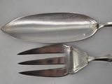 two spoons and a fork sitting on a table