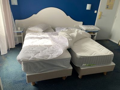 two twin beds in a small room with blue walls