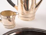 a silver plate with a silver pitcher and a silver plate with a silver plate and a silver plate with a silver plate and a silver plate with a silver