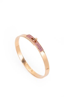 a gold ring with pink sapphire stones