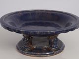 a blue bowl sitting on top of a white table