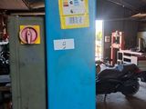 a blue pole with a sign on it in a garage