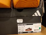 two pairs of shoes in a box on a table